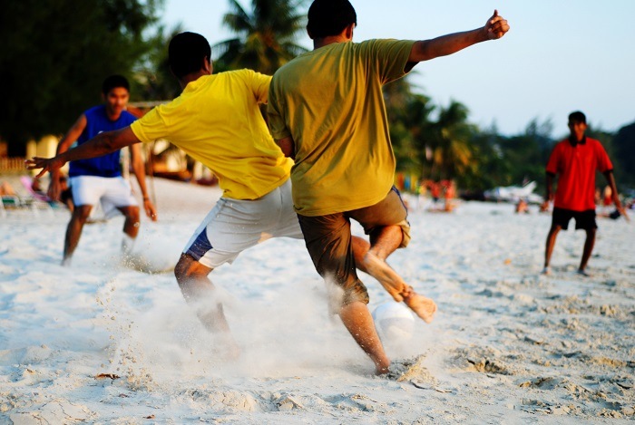 Playing soccer on the tropical beach.